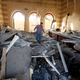 A man walks over rubble from a blast, seen inside the Islamic Art Museum after a bomb attack in downtown Cairo, January 24, 2014. A suicide bomber in a car blew himself up in the parking lot of a top security compound in central Cairo on Friday, killing at least four people in one of the most high-profile attacks on the state in months, security sources said.